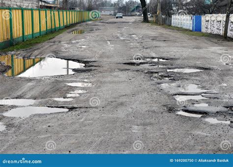 Dangerous Potholes In The Asphalt Rural Road. Road Damage Royalty-Free ...