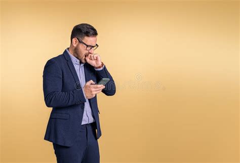 Frustrated Male Professional Manager Biting Hand And Checking Messages