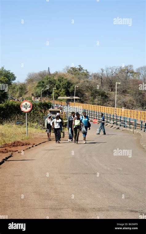 People crossing the border between Zimbabwe and Zambia along the ...