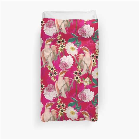 A Pink Floral Print Duvet Cover With White And Red Flowers On The