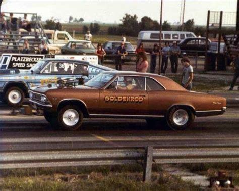 An Old Car With The Word Goldrod Painted On Its Side In Front Of Other