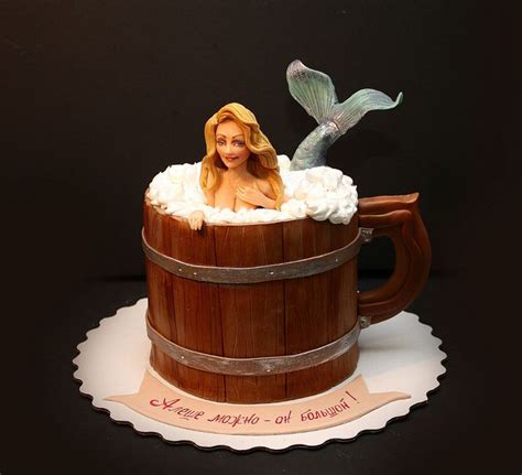 There Is A Cake Made To Look Like A Mermaid In A Barrel