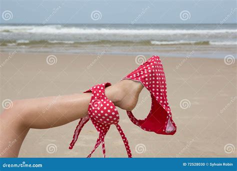 Girl On Beach Holding Bikini With Her Leg Stock Photo Image Of