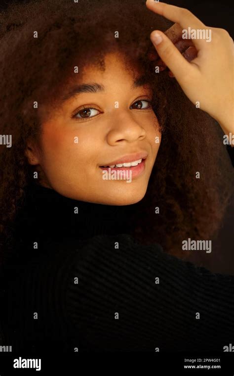 Portrait Of Attractive Smiling Curly African American Woman In Black