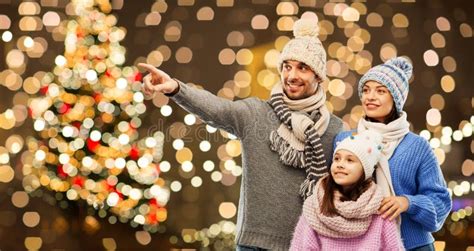 Happy Family in Winter Hats Over Christmas Lights Stock Photo - Image ...