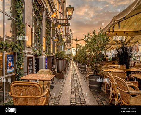 Walk With Colorful Restaurants On The Quayside Of Nyhavn Canal In