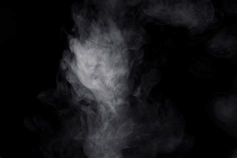 white smoke on black background for overlay effect. a realistic smoke ...