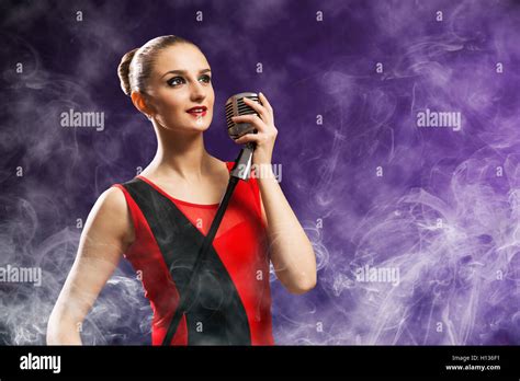 Beautiful Blonde Woman Singer With A Microphone Stock Photo Alamy