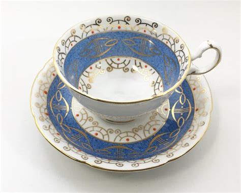 Two Cups And Saucers Are Sitting Side By Side On A White Surface With