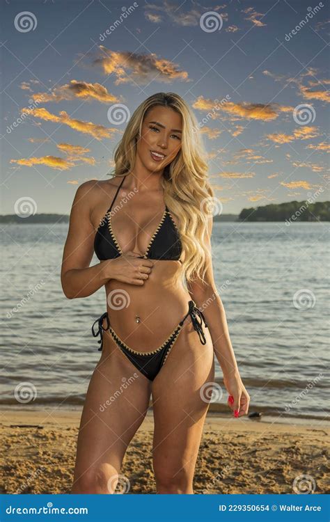 Lovely Blonde Bikini Model Posing Outdoors On A Caribbean Beach Stock