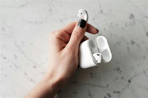 Photo Of Person Holding Apple Airpods · Free Stock Photo