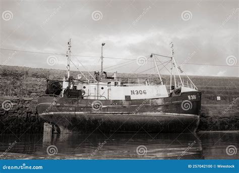 Grayscale Shot Of An Old Fishing Boat Docked At Balbriggan Harbor At