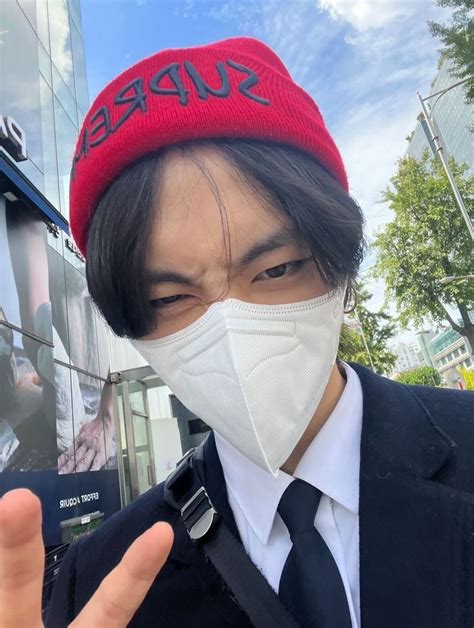 A Man In A Suit And Tie Wearing A Face Mask With The Word Supreme