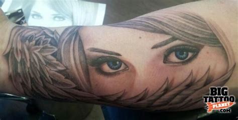 A Woman S Arm With An Artistic Tattoo Design On Her Left Arm And Blue Eyes