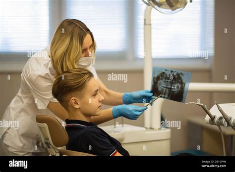 Dentist showing to patient x-ray the jaw at stomatology clinic Stock Photo - Alamy