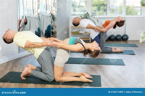 Couples Yoga Classes in Gym. Men and Women Meditate Together in Various Yoga Poses Stock Photo ...