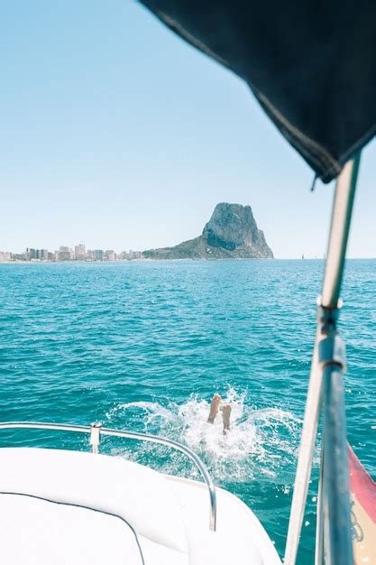 Premium Photo Man Diving Into Water From Boat