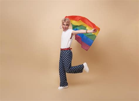 Free Photo Youth Asian Transgender LGBT Showing Rainbow Flag Isolated On Nude Color Background