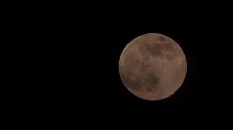 The Full Moon Is Seen In The Dark Sky