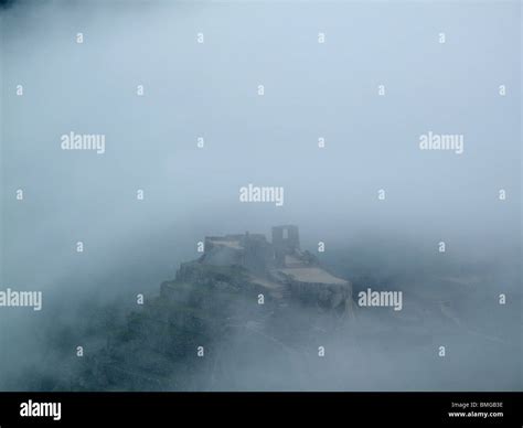 Early Morning Mist Over The Ancient Inca Ruins At Machu Picchu Near