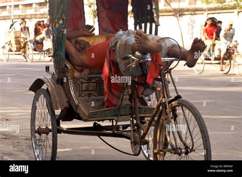 rickshaw bicycle hard work sleeping funny strange Stock Photo - Alamy