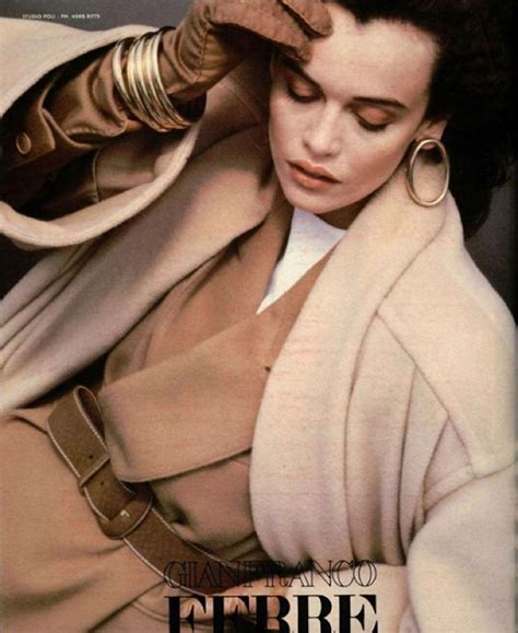 A Woman In A Trench Coat And Large Hoop Earrings On The Cover Of A Magazine