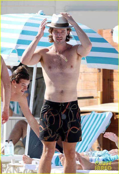 Patrick Schwarzenegger Looks Fit Going Shirtless At The Beach Photo