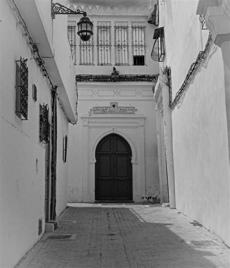 Black and White Photograph of an Old Town House with a GateFree