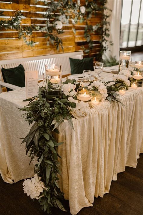 Sweetheart Table With Faux Floral And Greenery With White Bench And