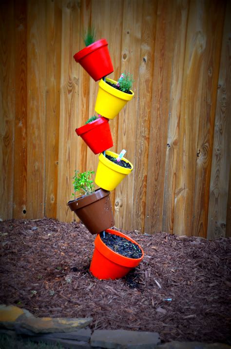 stacked pots with herbs - this will save room and make growing herbs