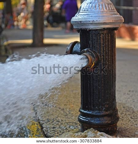 Open Fire Hydrant Water Flowing Vigorously From Open Fire Hydrant On