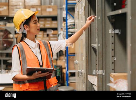 Engineer Woman Work In Hardware Products Warehouse Store Using Tablet