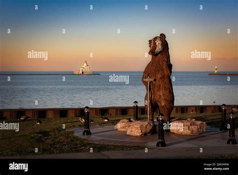 The sun sets on Shipbuilder, a 12-foot tall badger statue, created by sculpter Carl Vanderheyden ...