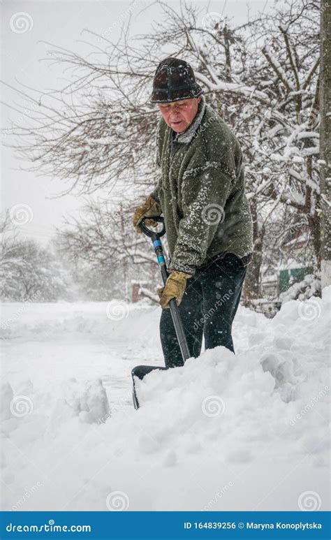 Man With A Shovel Cleans The Track From The Snow Stock Photo Image Of