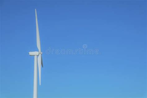 Close Up Side View Of Windmills With Blue Sky Background On A Sunny Day