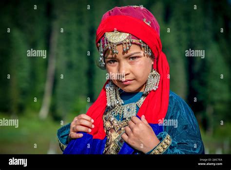 A Girl Dressed In A Traditional Kashmiri Dress Poses For A Photo On A