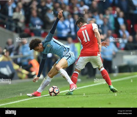 Arsenal S Mesut Ozil Right And Manchester City S Leroy Sane Battle