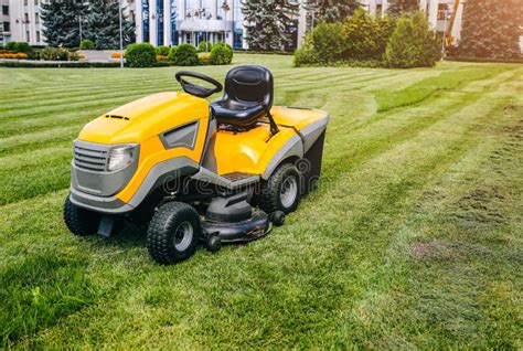 Grass Cutter In The Work Machine For Cutting Lawn Is Standing Outdoors