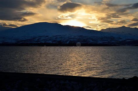 Golden Vibrant Sunset Over Snowy Mountain And Fjord Stock Image Image