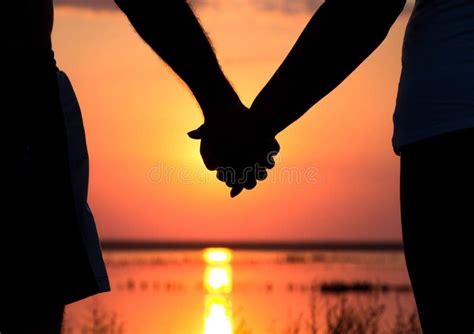 Couple At Sunset Holding Hands Stock Photo Image Of Hold Silhouette