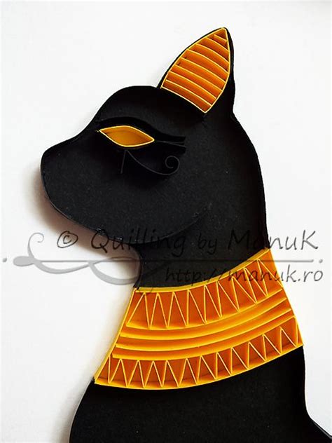 A Black Cat With An Orange And Yellow Scarf On It S Head Sitting Next