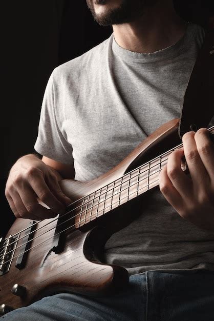 Premium Photo Man Playing Four String Electric Bass Instrument Solo