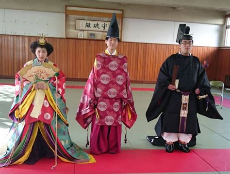 A Woman And Two Men Dressed In Heian Robes At A Kimono Demonstration