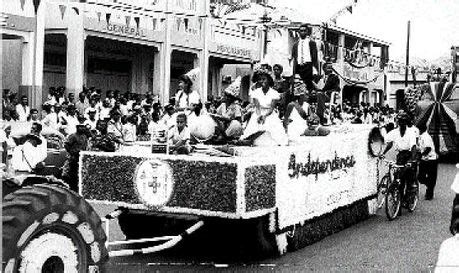 A Large Crowd Watches As The Float Parade Passes Through May Pen On