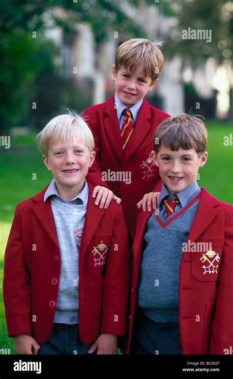 Portrait of three boys smiling in school uniform, England Stock Photo ...