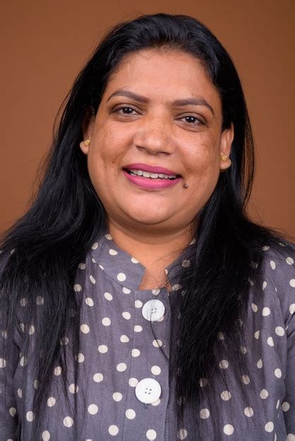 Premium Photo Portrait Of Mature Indian Woman Against Brown Background