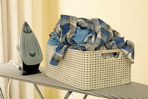 Iron and Basket with Clothes on Ironing Board Isolated Stock Photo - Image of full, electric ...