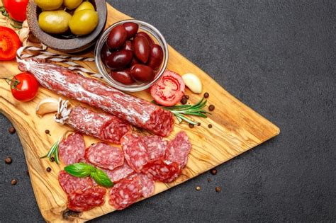 Premium Photo Dried Organic Salami Sausage On Wooden Cutting Board