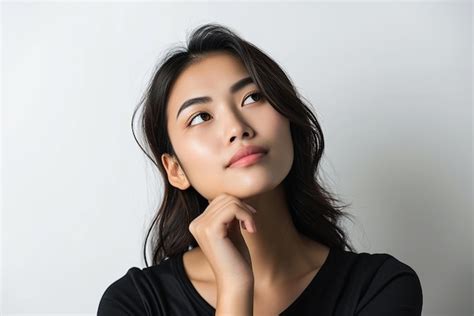 Premium Photo Portrait Of Thinking Young Woman On Isolated White