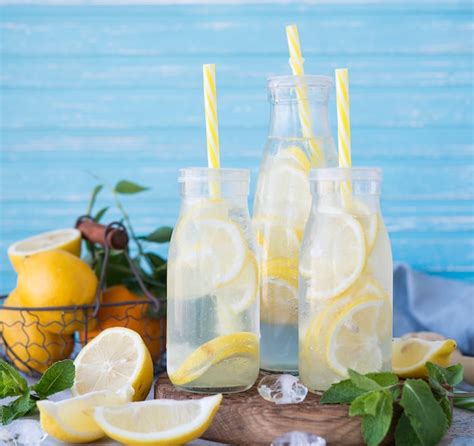 Premium Photo Homemade Lemonade With Lemon Mint And Ice In Bottles